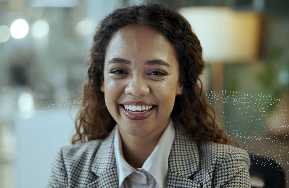 Close-up of a young, professional woman smiling into the camera.