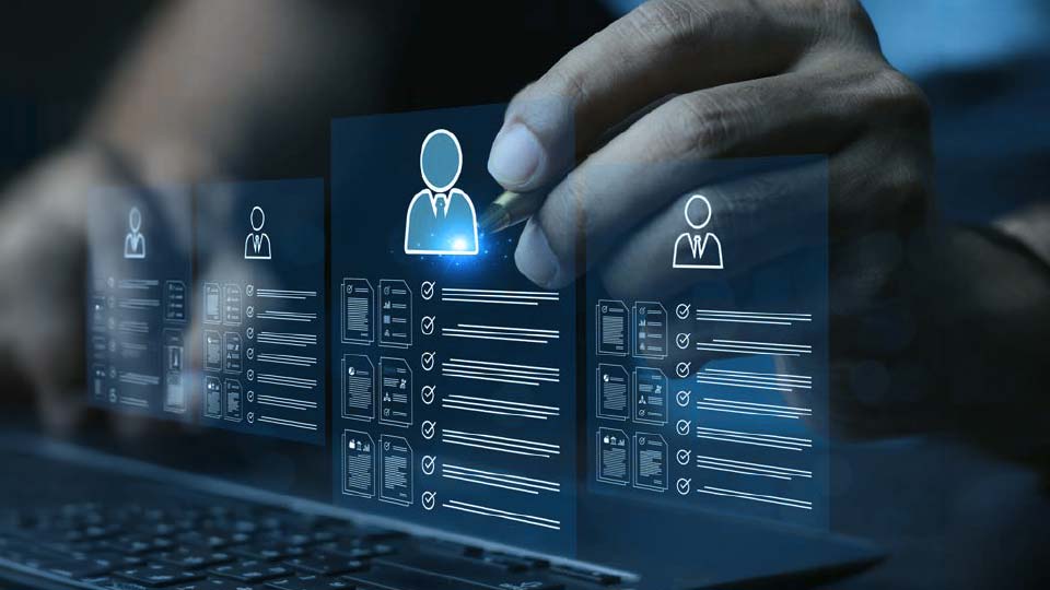 Hand selecting a glowing digital profile card among multiple candidate resumes displayed above a laptop keyboard.