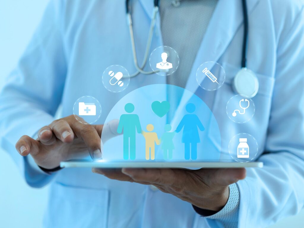 A doctor holds a glowing digital healthcare interface showing a family, medical symbols, and a stethoscope icon, conveying caring, connected care.