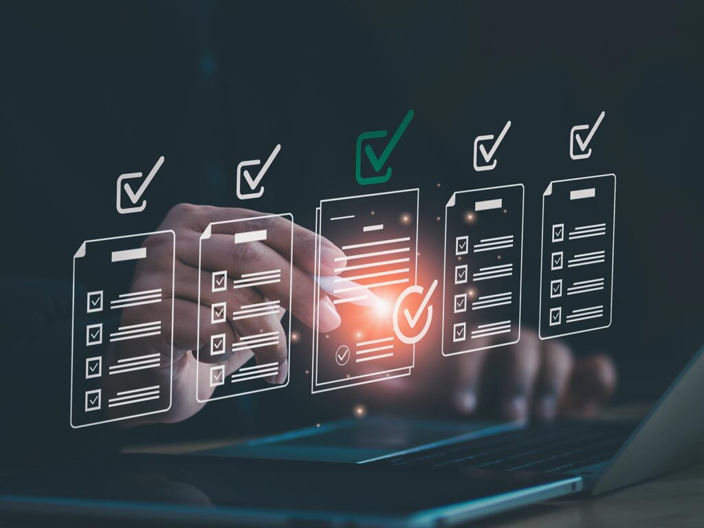 A hand selects a checked digital form on a glowing laptop, amid floating checklist icons—suggesting online review, task completion, and efficient technology.
