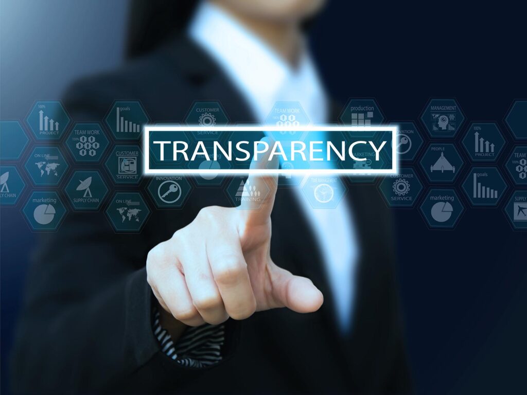 A businessperson in a dark suit presses a glowing “TRANSPARENCY” button amid blue data and analytics icons, creating a sleek, professional tone.