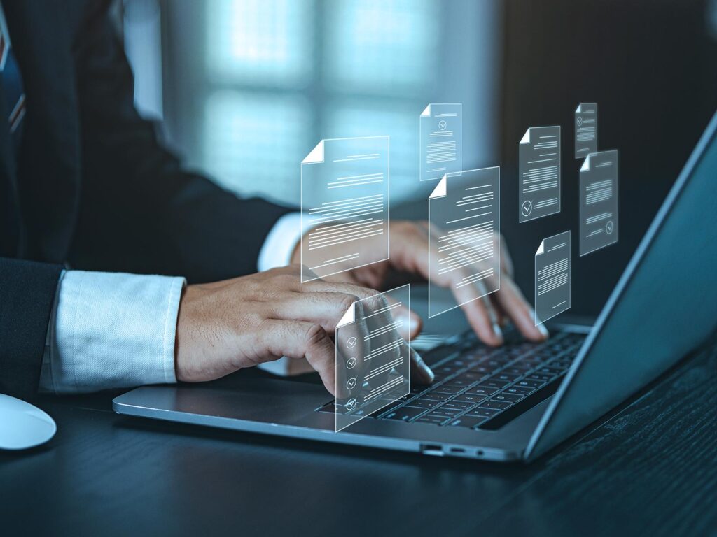 Businessperson typing on a laptop with floating digital document and checklist icons symbolizing electronic document management.